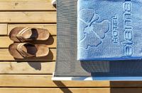 a pair of sandals sitting next to a towel at Delamar 4*Sup-Adults only (18+) in Lloret de Mar