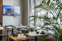 a dining room with tables and a large window at Oriental Elegant Hotel in Libeiling