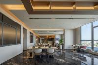 a conference room with tables and chairs and windows at Oriental Elegant Hotel in Libeiling