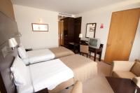 a hotel room with two beds and a television at White Sands Hotel in Portmarnock