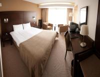a hotel room with a large bed and a desk at White Sands Hotel in Portmarnock