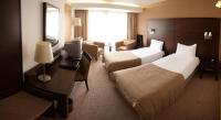 a hotel room with two beds and a desk at White Sands Hotel in Portmarnock