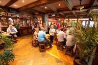 a group of people sitting at tables in a bar at White Sands Hotel in Portmarnock