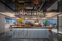 a bar in a restaurant with a counter with drinks at Holiday Inn Yiwu Center by IHG in Yiwu