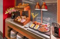 a buffet with different types of food on a counter at Beijing Tiananmen Square Manxin Hotel in Beijing