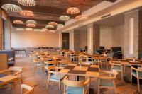 ein Restaurant mit Tischen, Stühlen und Kronleuchtern in der Unterkunft Soaltee Westend Lakeside Pokhara in Pokhara