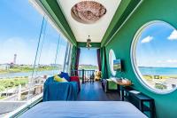 a bedroom with green walls and large windows at Malibu OceanView Homestay in Magong