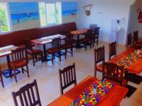 een restaurant met tafels en stoelen met kleurrijke versieringen bij Luxury 2BR Apartments in Kisumu