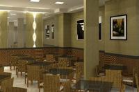 a restaurant with tables and chairs in a room at Skala Traveling Hotel in Cuiabá
