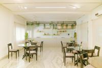 a restaurant with tables and chairs in a room at VSR Vriksha Wellness Nature Cure Center in Hyderabad