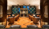 a dining room with chairs and a wall of wine bottles at The Prince Gallery Tokyo Kioicho, a Luxury Collection Hotel in Tokyo