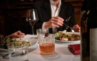 a person sitting at a table with a plate of food at The Huntington Hotel in San Francisco