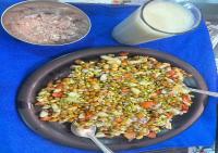 a pan of food on a table with a bowl of food at Akshay premium suites1 BHK Serviced Apartments Near Artemis Hospital Sector 52 in Gurgaon