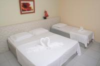 two beds in a hotel room with swans on them at JR Hotel in João Pessoa