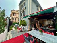 a woman sitting at a table outside of a restaurant at Casa Florya Suites in Istanbul