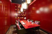 a red dining room with a red table and chairs at Chinese Culture Boutique Hotel TangFu, Liangma Riverside, Near Sanlitun & Embassy Area, Metro Access, 20min to Wangfujing, Forbidden City & Tian'anmen Square, Airport & the Great Wall Travel Assistance in Beijing