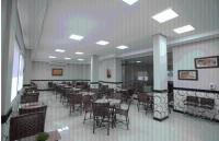 a dining room with tables and chairs in a building at Skala Traveling Hotel in Cuiabá