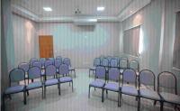 a room with a bunch of blue chairs in it at Skala Traveling Hotel in Cuiabá