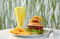 een bord met een hamburger en friet en een drankje bij Villa 2527 San Lameer in Southbroom