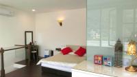 a bedroom with a bed with red pillows on it at Qinbianlu B&amp;B in Jiufen