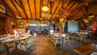 a restaurant with wooden ceilings and tables and chairs at Abant Niz in Bolu