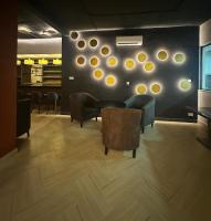 a room with chairs and a table and a wall with dots at DOMO By Design Union in Lagos