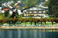 a large building next to a body of water at Hotel Altmünsterhof in Altmünster