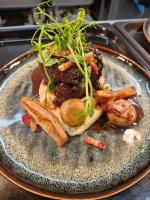 een bord met vlees en groenten erop bij The Station Hotel Insch in Insch