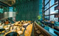 a lobby of a building with chairs and tables at The Prince Gallery Tokyo Kioicho, a Luxury Collection Hotel in Tokyo