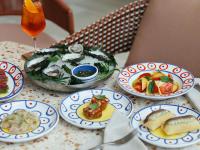 una mesa cubierta con platos de comida y una ensalada en Elysium Noosa Resort - MGallery Collection, en Noosa Heads