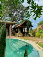 a house with a swimming pool in front of a building at Nature Transit villa 