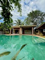 a swimming pool in front of a house at Nature Transit villa 