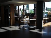 a living room with a couch and a table and chairs at KOS Pilar Hotel in Pilar