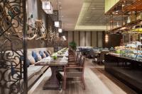 ein langer Speisesaal mit Tischen und Stühlen in der Unterkunft Wanda Realm Jingzhou in Jingzhou