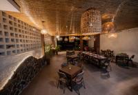 a restaurant with tables and chairs and chandeliers at Bayview Garden Resort in Panglao