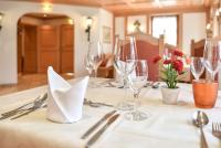 a table with wine glasses and a white table cloth at Hotel Gasthof Süßer Grund in Albstadt