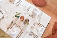 a white table with glasses and silverware on it at Hotel Gasthof Süßer Grund in Albstadt