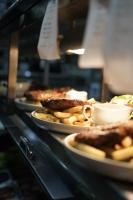 een rij borden met voedsel op een toonbank bij Vineyard Cottage at Oakdene in Wallington