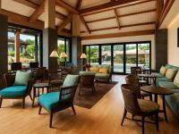 a lobby with chairs and tables and windows at Sheraton Kauaʻi Resort Villas- STUDIO in Koloa