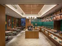 a restaurant with tables and chairs and a bar at Orange Nanjing Baijia Lake Xiaolongwan Subway Station Hotel in Jiangning