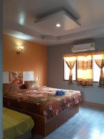 Postel nebo postele na pokoji v ubytování สิชล บ้านอุ๊ รีสอร์ท