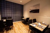 a restaurant with tables and chairs in a room at Westend Hotel & Bar in Nairn