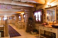 een blokhutkeuken met houten wanden en tafels. bij Hotel U dobrého pastiera in Ružomberok