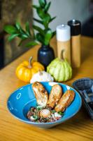 a blue plate of food with bread and vegetables on a table at Eco Nieborów in Nieborów