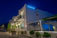 a white building with a sign on it at night at Hotel Cyclades in Parikia
