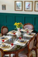 een eettafel met een vaas met bloemen erop bij Jobner Haus Jaipur in Jaipur