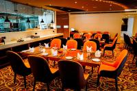 een vergaderruimte met tafels en stoelen en een keuken bij Ramadia Grand Holiday Resort in Panadura