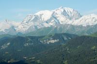 a snow covered mountain range with trees in the foreground at Cabane entre terre et ciel in Saint-Nicolas-la-Chapelle