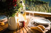 a table with plates and glasses and bread on it at Cabane entre terre et ciel in Saint-Nicolas-la-Chapelle