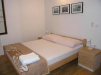 Postel nebo postele na pokoji v ubytování Apartmani Dolencic